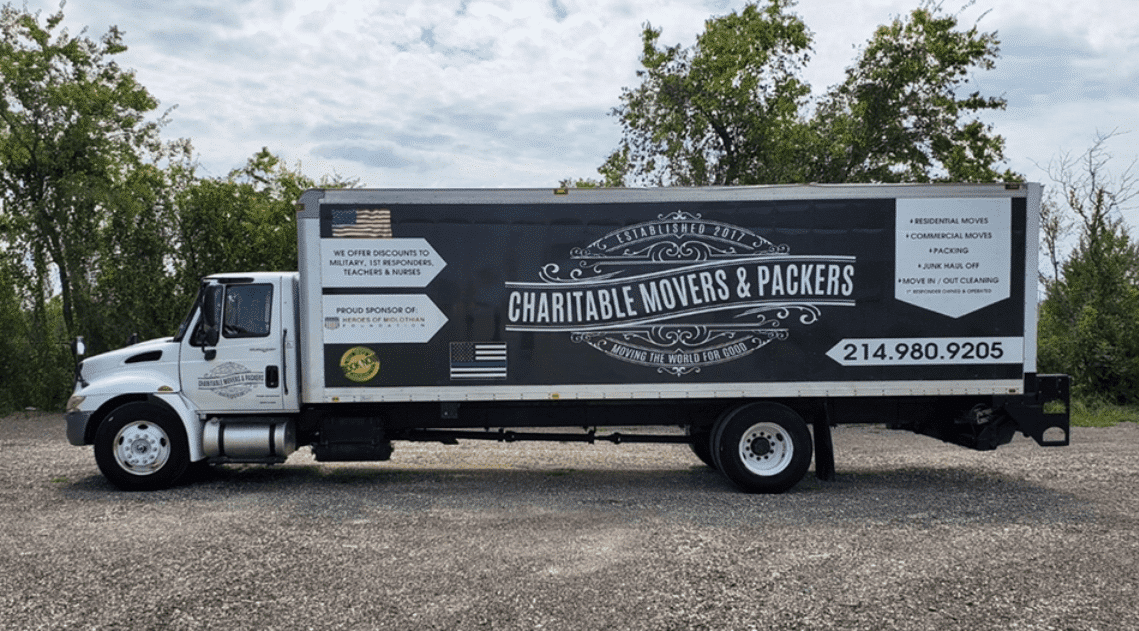 Image of the Charitable Movers & Packers moving truck with logo.